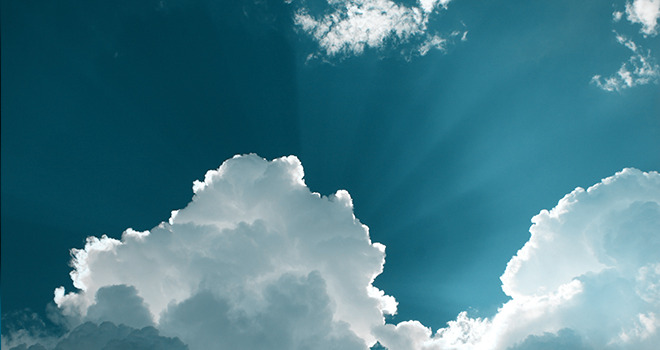 Blue sky with clouds and rays of sunlight
